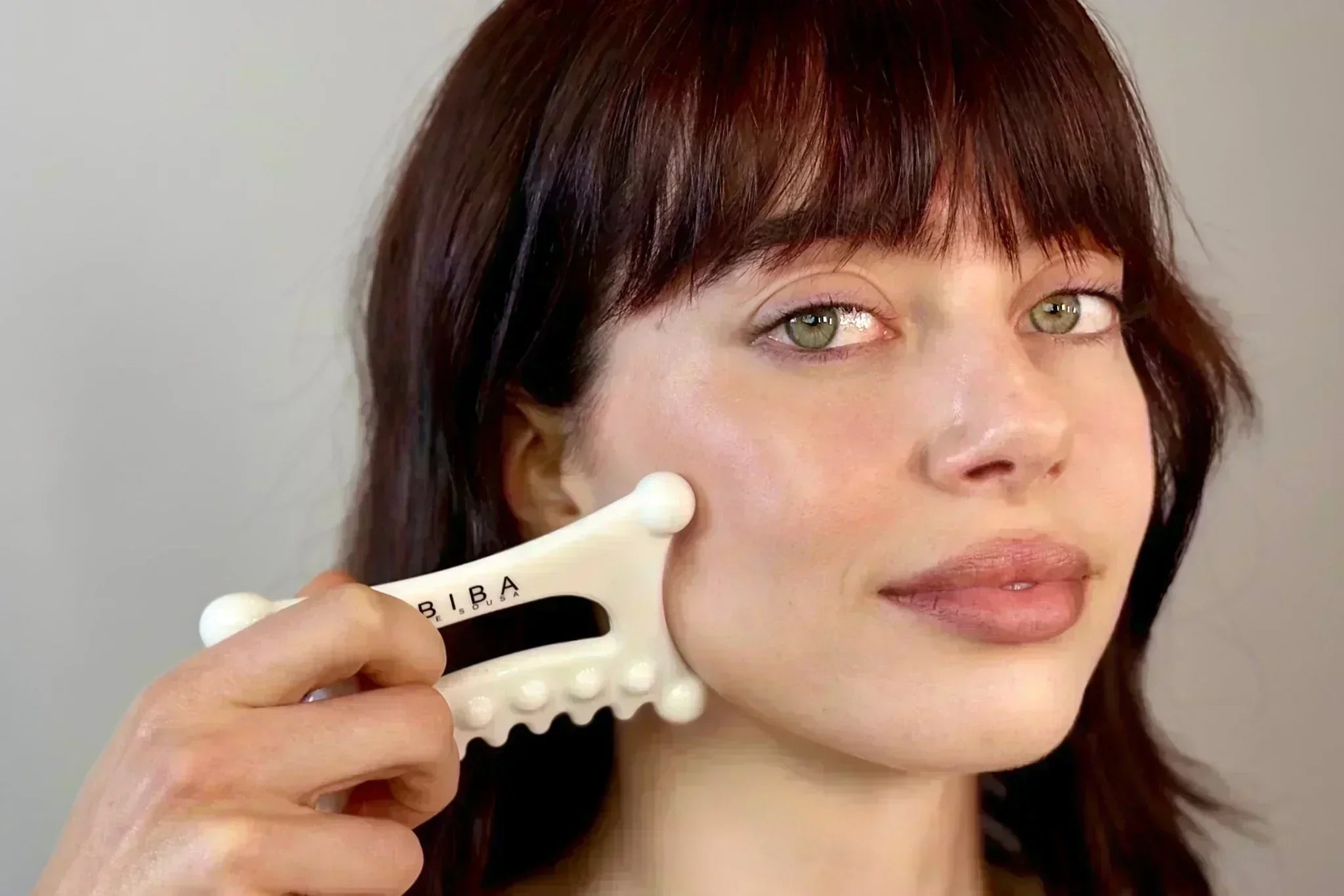 Woman using the Biba Fascia Tool on her cheek