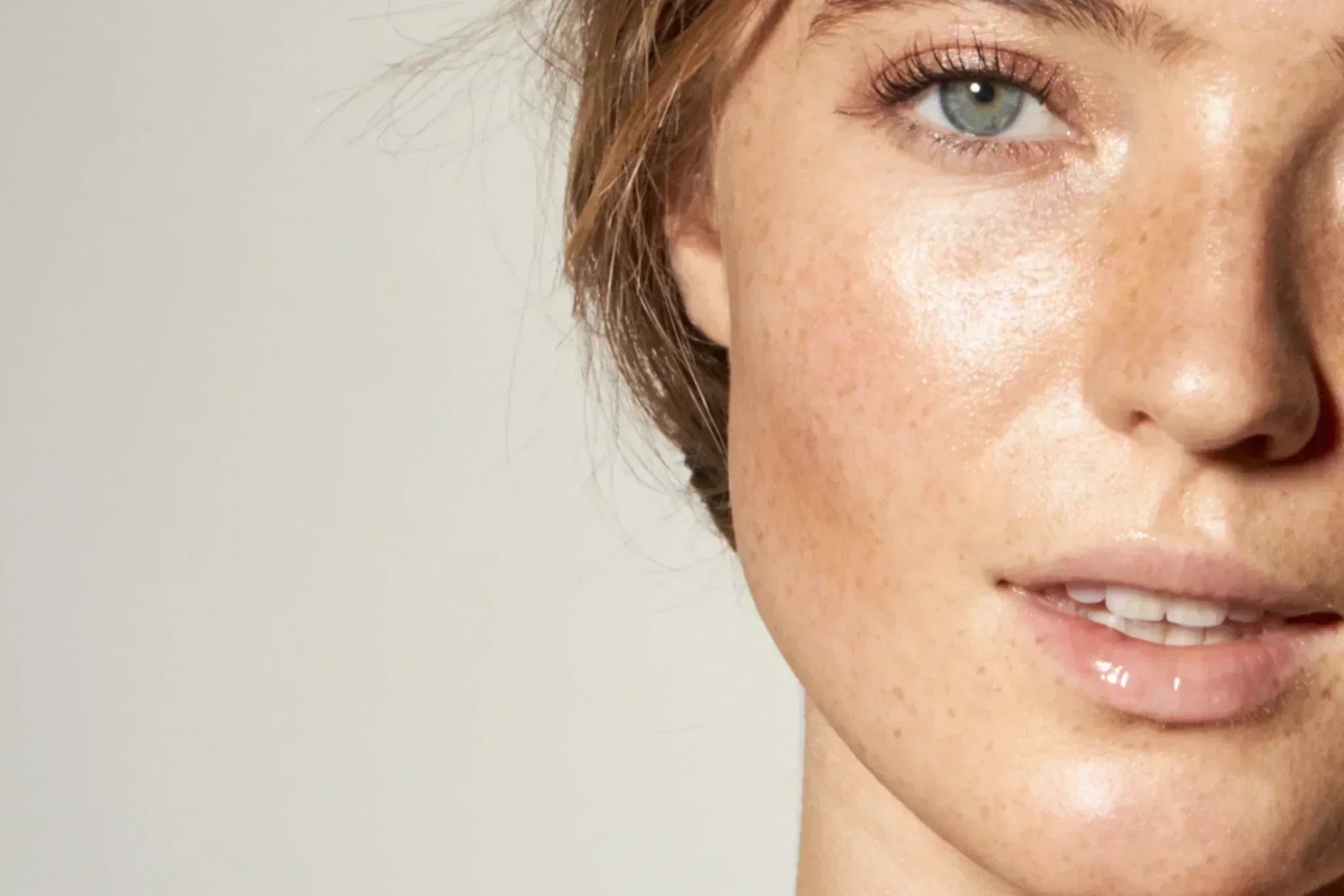 Close-up of a woman's glowing, smooth skin showing refined texture and healthy luminosity.