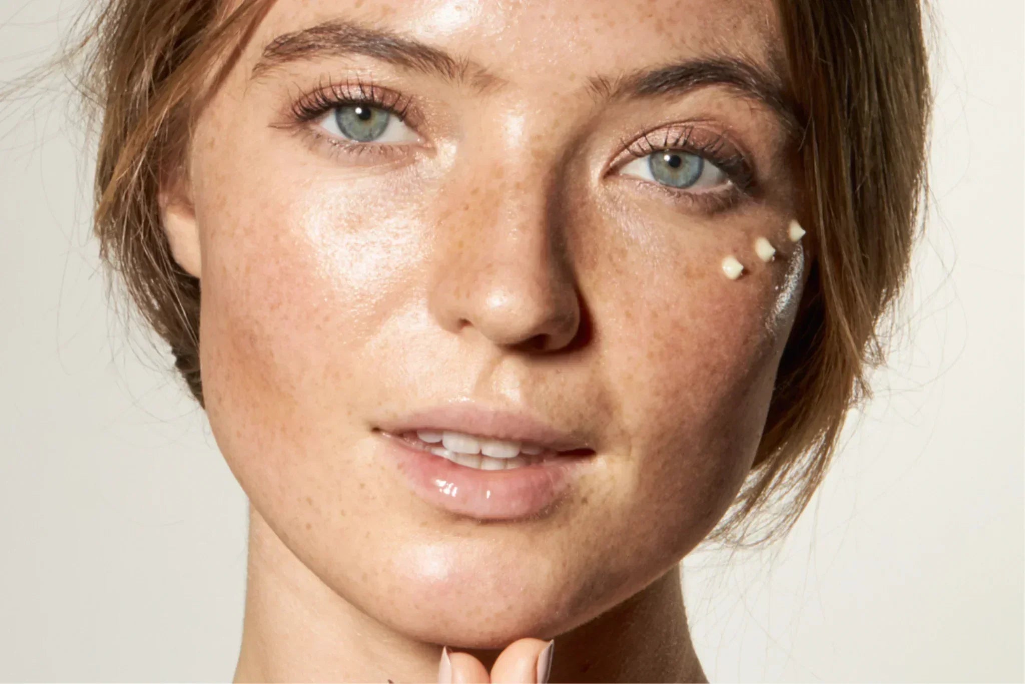 Close-up of natural skin around the eye area with lightweight eye cream applied, highlighting hydration and delicate eye skincare