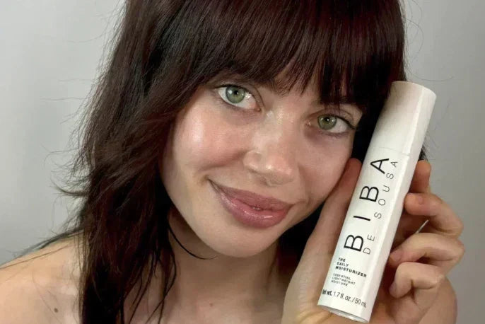 Model holding Biba Los Angeles Daily Moisturizer, a lightweight moisturizer designed to support balanced hydration and healthy-looking skin
