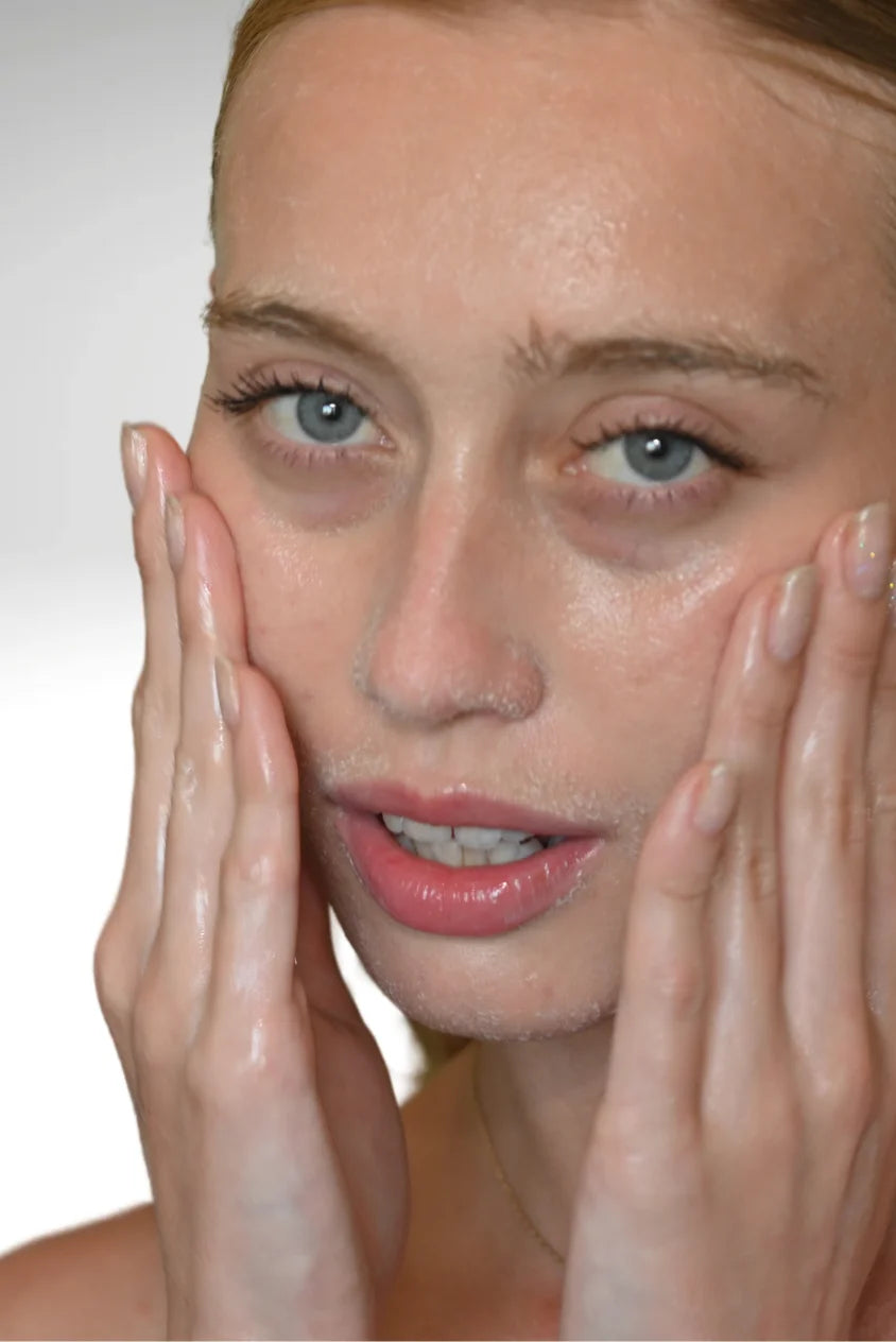 woman cleansing face with Biba Los Angeles Daily Cleanser exfoliating AHA face wash for smoother, brighter skin