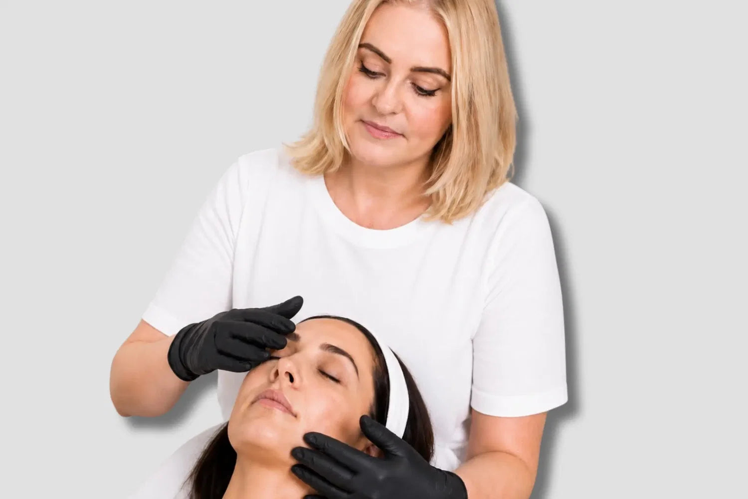 Celebrity Esthetician Biba de Sousa analyzing customer's skin