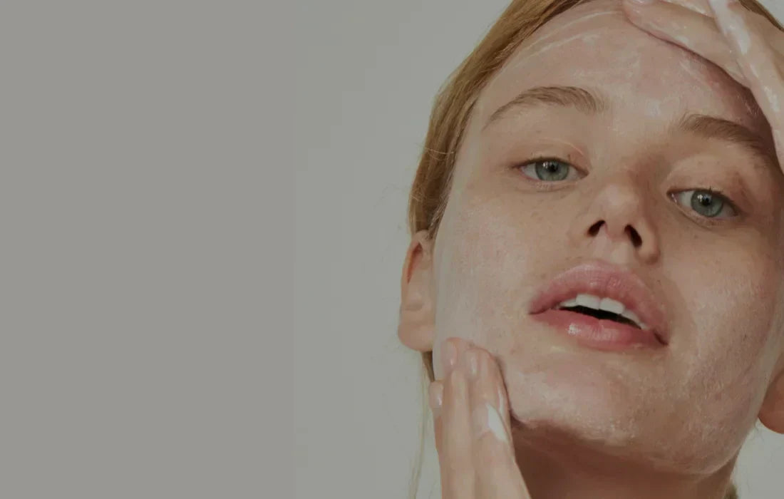 Close-up of a woman cleansing her face with water and gentle hand motions