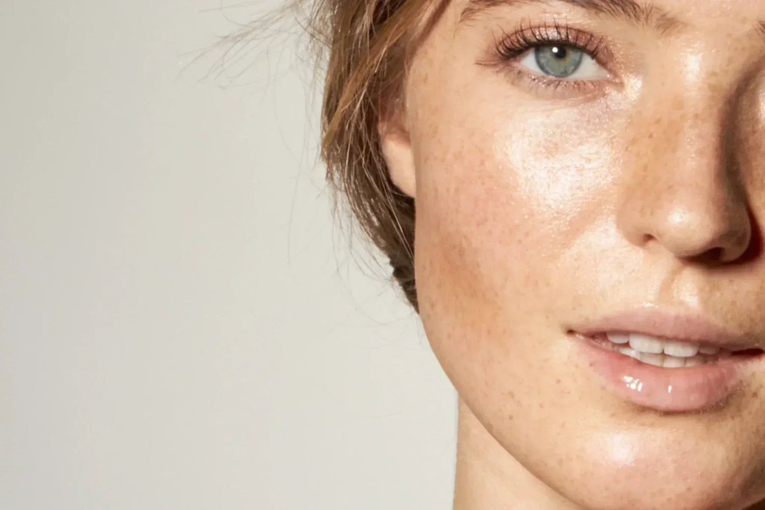 Close-up of a woman's glowing, smooth skin showing refined texture and healthy luminosity.