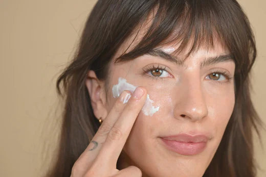 Close-up of model applying moisturizer to the face, illustrating gentle skincare for sensitive skin and barrier support