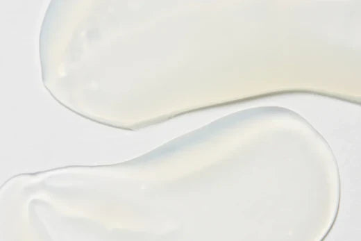 Image showing a close-up of translucent skincare serum textures spread across a white surface, representing antioxidant-rich skincare formulas.