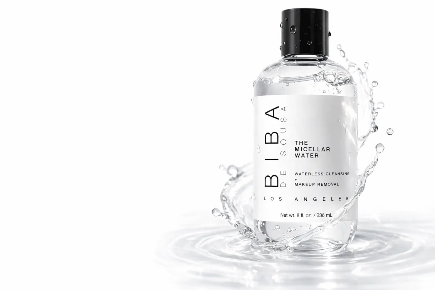 White bottle of BIBA Los Angeles The Micellar Water with black cap displayed on neutral beige pedestal blocks against a soft gradient background. Minimalist white label with vertical “BIBA” text. Clean, modern, studio-style product presentation.