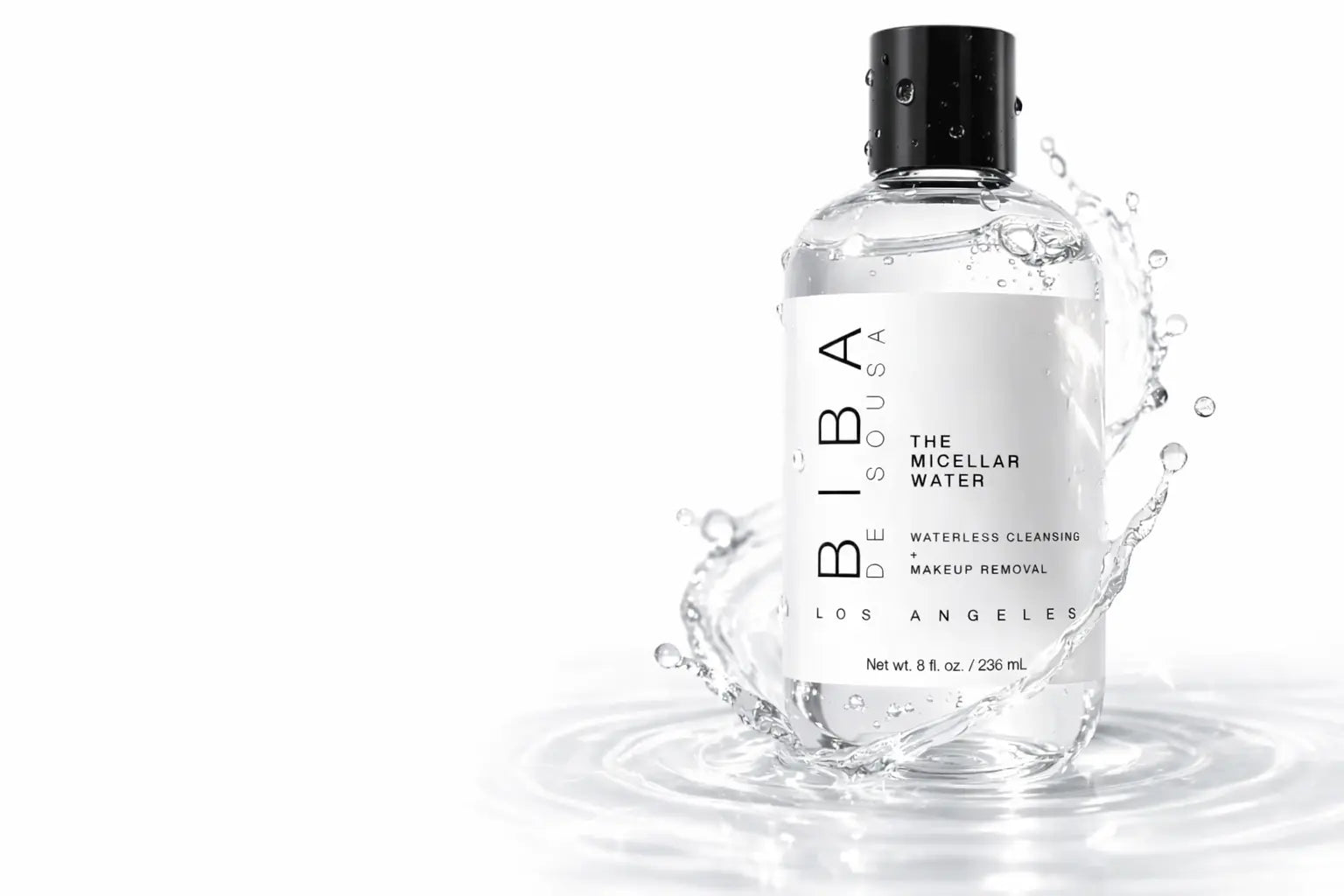 White bottle of BIBA Los Angeles The Micellar Water with black cap displayed on neutral beige pedestal blocks against a soft gradient background. Minimalist white label with vertical “BIBA” text. Clean, modern, studio-style product presentation.