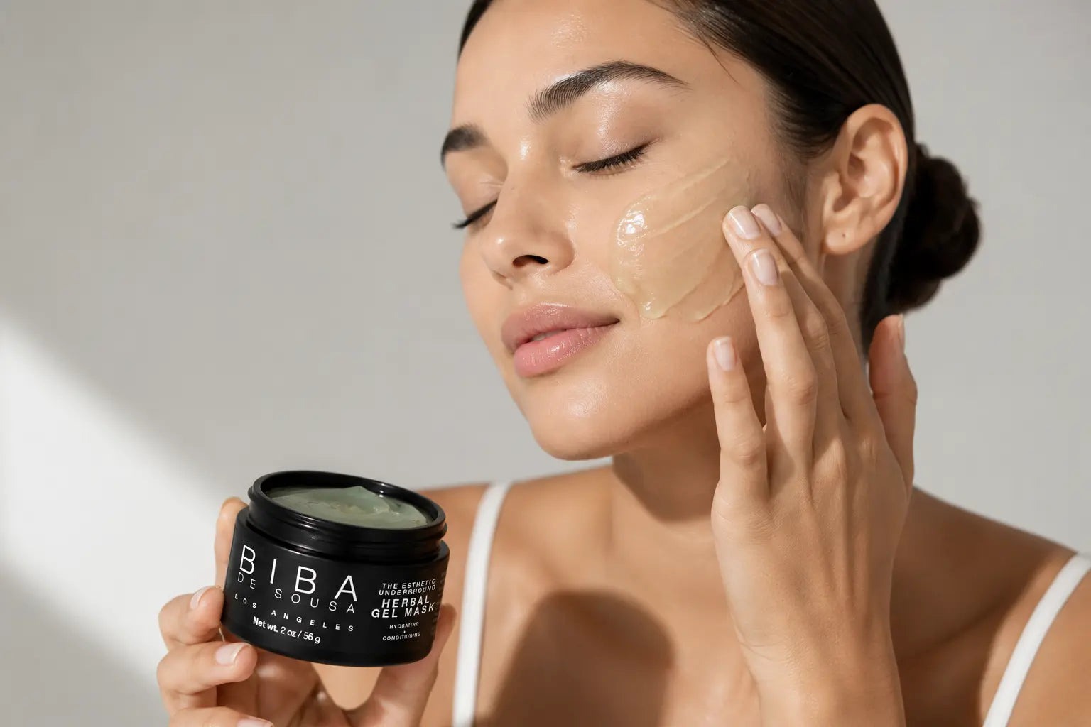 Woman applying BIBA Herbal Gel Mask with hyaluronic acid for soothing hydration and skin barrier support.