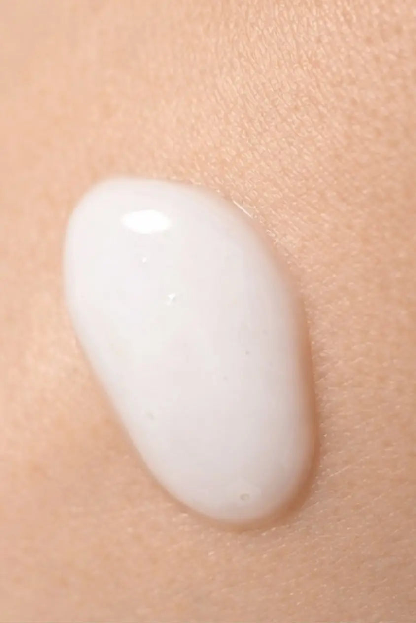 White acne treatment gel texture applied on skin close-up