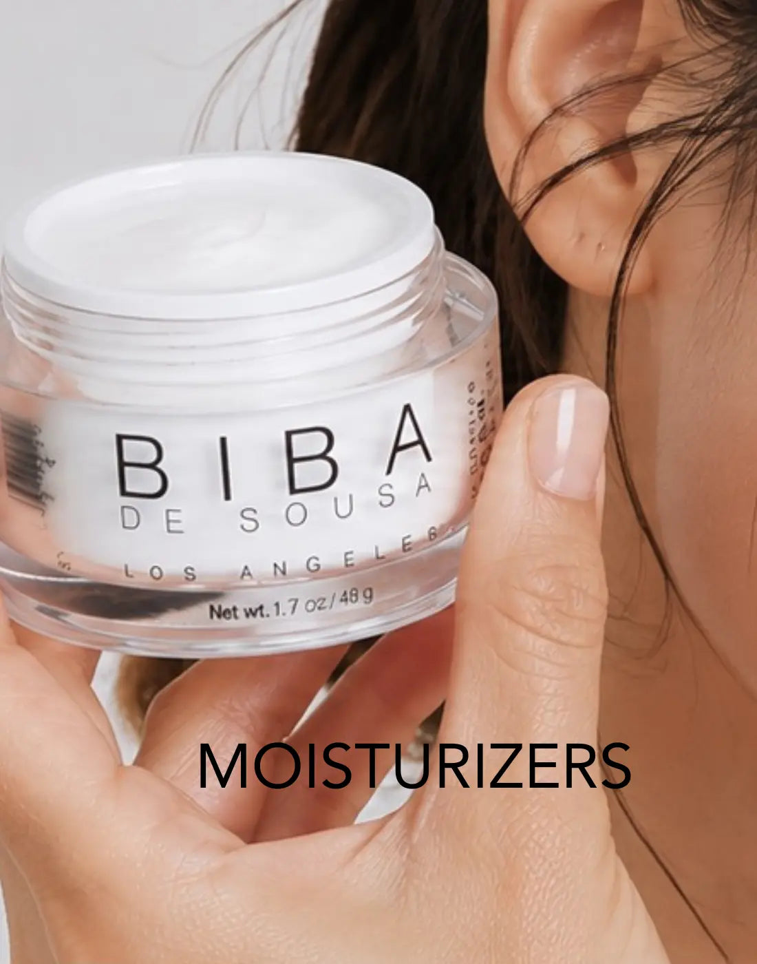 Model holding BIBA Cream Barrier moisturizer in an open jar. Barrier-supporting facial moisturizer by BIBA Los Angeles.