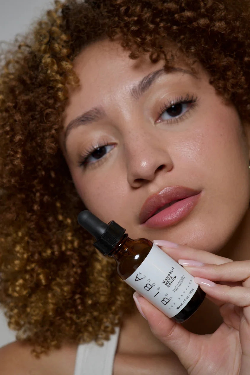 Woman holding Biba de Sousa Los Angeles Mandelic Meta Serum, showcasing smooth, clear skin and gentle exfoliation for acne-prone and sensitive skin