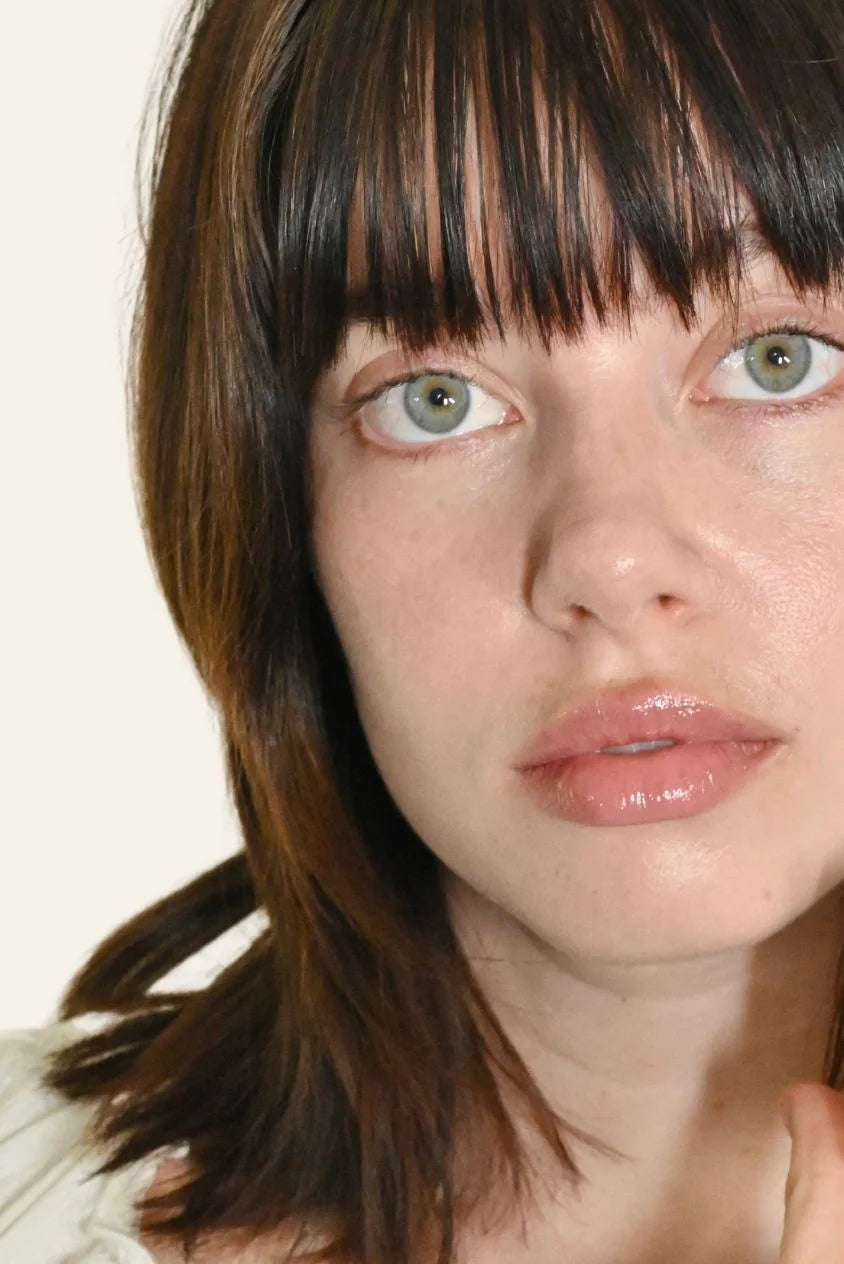 Close-up of woman with smooth, balanced skin and natural glow, showcasing a hydrated, clear complexion for normal to oily skin.
