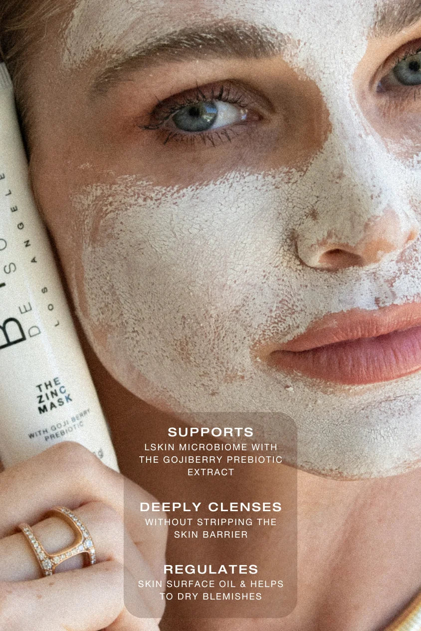 Model wearing a zinc clay face mask while holding the Biba Los Angeles Purifying Zinc Mask tube, demonstrating a barrier-respectful clay mask for pore purification and acne-prone skin