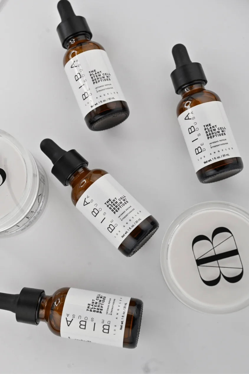Multiple Biba de Sousa peptide serum bottles with Onerta Cream Barrier in skincare flat lay arrangement


